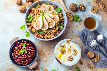 close-up view of tasty healthy couscous salat with figs fruits, nuts and pomegranate seeds