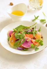 Citrus salad with radishes, carrots and arugula, vertical 