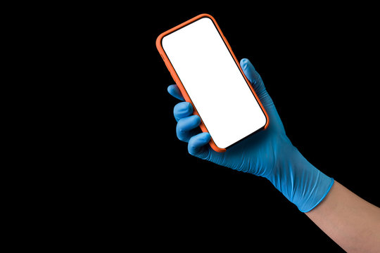 Doctor's hand in medical gloves holding phone isolated on black