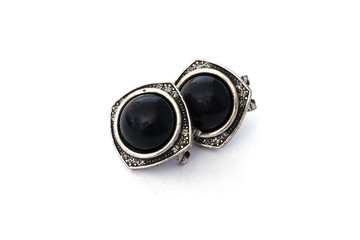 Nineteenth-century earrings on a white background. Antique decoration with black stone. Ancient Greek earrings isolate. Earrings with black gem. Female Earrings Isolate