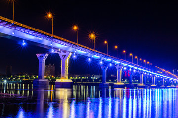 Colorfully lit bridge and the night city