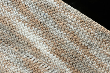 Fragment of crocheted canvas of melange yarn closeup. Abstract background