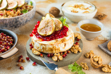 Camembert cheese with figs and honey. Selective focus. Close view
