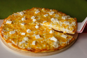 Hot italian pizza on a table with vegetables