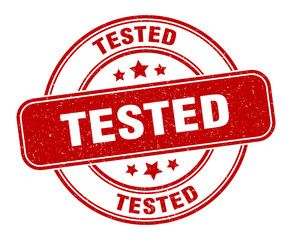 tested stamp. tested label. round grunge sign © Aquir