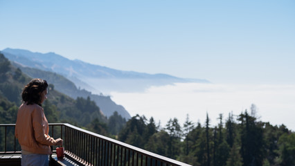 girl in front of a fog sea, california