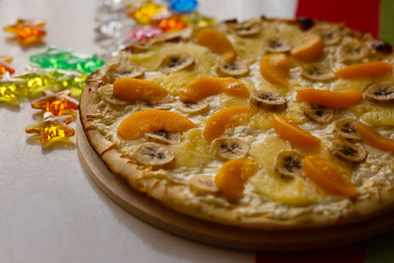 Sweet fruit pizza - bananas, peaches, oranges