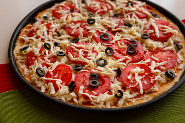 Raw pizza in a pan. Italian food cooking