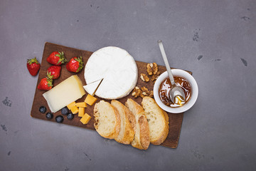 Cheese, wine bread and strawberries.