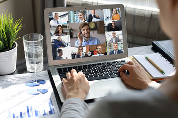 Business woman talking to her colleagues in video conference. Business team working from home using laptop.
