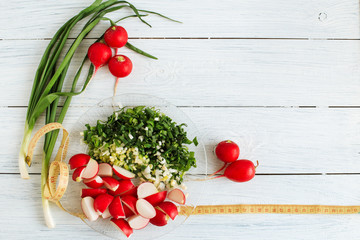Fresh vegetable salad, sliced radishes and onions on a plate, detox diet , healthy food