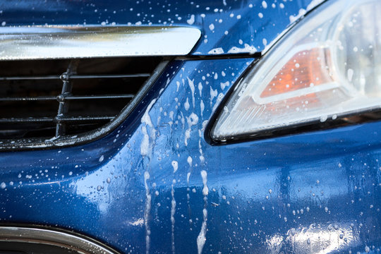 Head Light And Car Grill With Foam During Car Washing, Close Up View