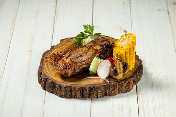 Roasted grilled beef meat steak on wooden board