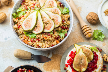 close-up view of tasty healthy couscous salat with figs fruits, nuts and pomegranate seeds