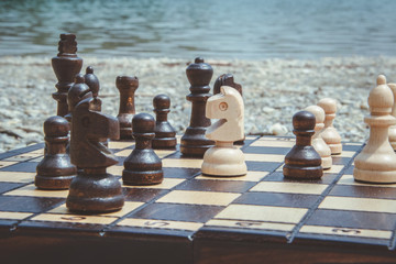 Playing chess on a lakeside in Slovakia, Ivanka pri Dunaji. Chessboard on a stones.