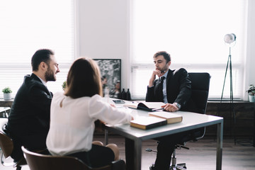 Friendly colleagues speaking at workplace