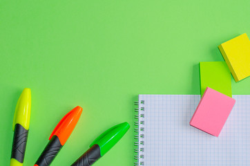 Back to school concept. School and office supplies on office table, green background. Flat lay with copy space.