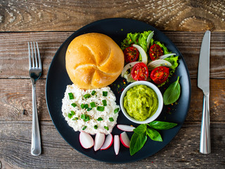 Breakfast - cottage cheese, bun, guacamole and vegetables
