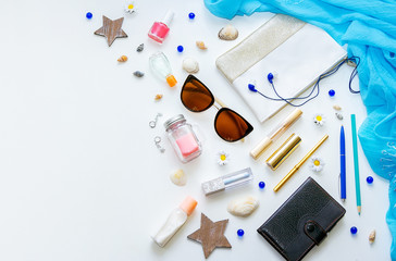 Outfit of young woman or modern teenager girl on white background – cosmetic and lifestyle accessories. Flat lay objects. 