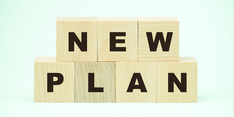 new plan text on wooden blocks business development concept