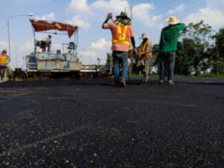 Picture blurred asphalt road construction By using heavy machinery