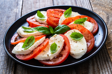 Caprese salad on wooden board 