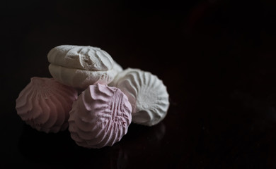 Delicious, beautiful marshmallow with texture against black background. Focus on light sweets confectionery