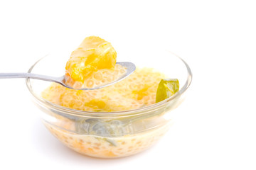 A high key picture of "pengat labu" on isolated white background.  South East Asia dessert made of pumpkin, coconut milk, sago and pandan leaf for fragrance.