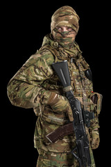 One soldier holding assault rifle. Uniform conforms to sub-unit of Russia's special forces Alpha Group FSB. Shot in studio. Isolated with clipping path on black background