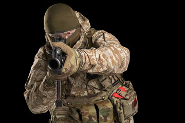 Soldier holding assault rifle and shooting. Uniform conforms to special services of the Russian...