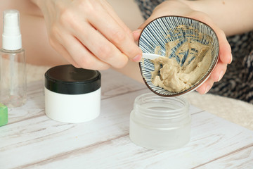 DIY cosmetics. hands in the frame create a cream of different ingredients. - 349809253