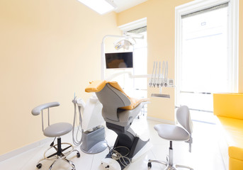 Modern dentist chair in well equipped stomatology room
