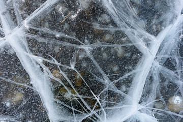 Beautiful ice of Lake Baikal with abstract cracks