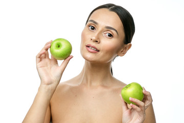 close-up portrait of a girl with clear skin holding a apple to her face, isolated on a white background