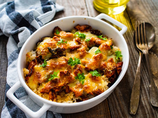 Rice casserole with barbecue chicken breast, cheese and vegetables
