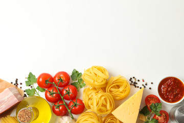 Composition with pasta and ingredients for cooking on white background, top view