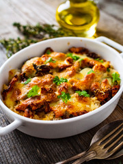 Rice casserole with barbecue chicken breast, cheese and vegetables
