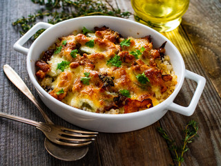 Rice casserole with barbecue chicken breast, cheese and vegetables
