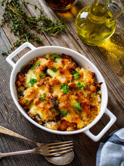 Rice casserole with barbecue chicken breast, cheese and vegetables
