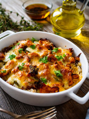 Rice casserole with barbecue chicken breast, cheese and vegetables
