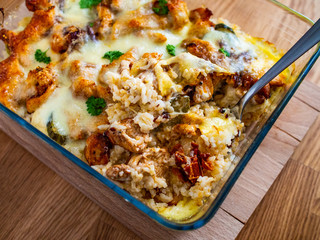 Rice casserole with barbecue chicken breast, cheese and vegetables
