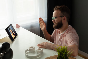 Handsome young man using digital tablet at home. Student men resting in his room. Home work or study, freelance concept