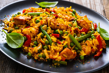 Paella chicken on wooden background
