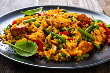 Paella chicken on wooden background
