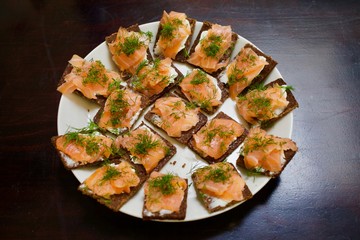 Platter with tasty rye bread with smoked salmon and dill. Perfect Midsummer food or and party