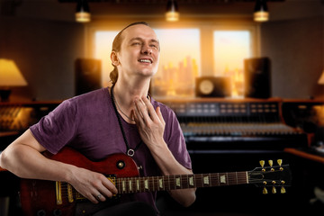 Fototapeta na wymiar Professional musician recording electric guitar in a recording studio.