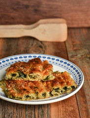 Traditional Turkish pastry with spinach. (Turkish Name: Ispanakli Kol Boregi). Handmade pastry with spinach filling.