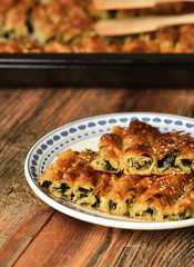 Traditional Turkish pastry with spinach. (Turkish Name: Ispanakli Kol Boregi). Handmade pastry with spinach filling. .
