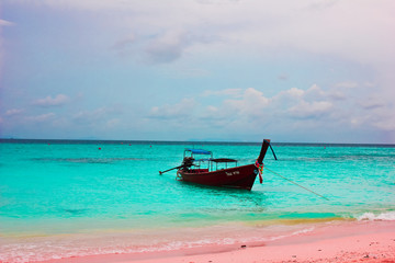 Turquoise blue waters, canoe in Thai Waters