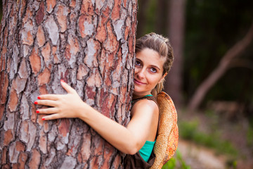 Young woman embracing a tree